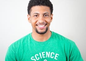 Portrait of a smiling young man wearing a green T-shirt with science text.